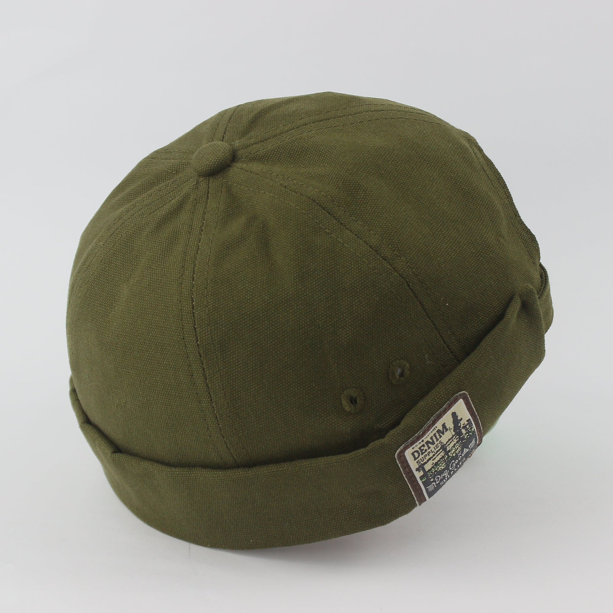 Green cap with a patch on a white background