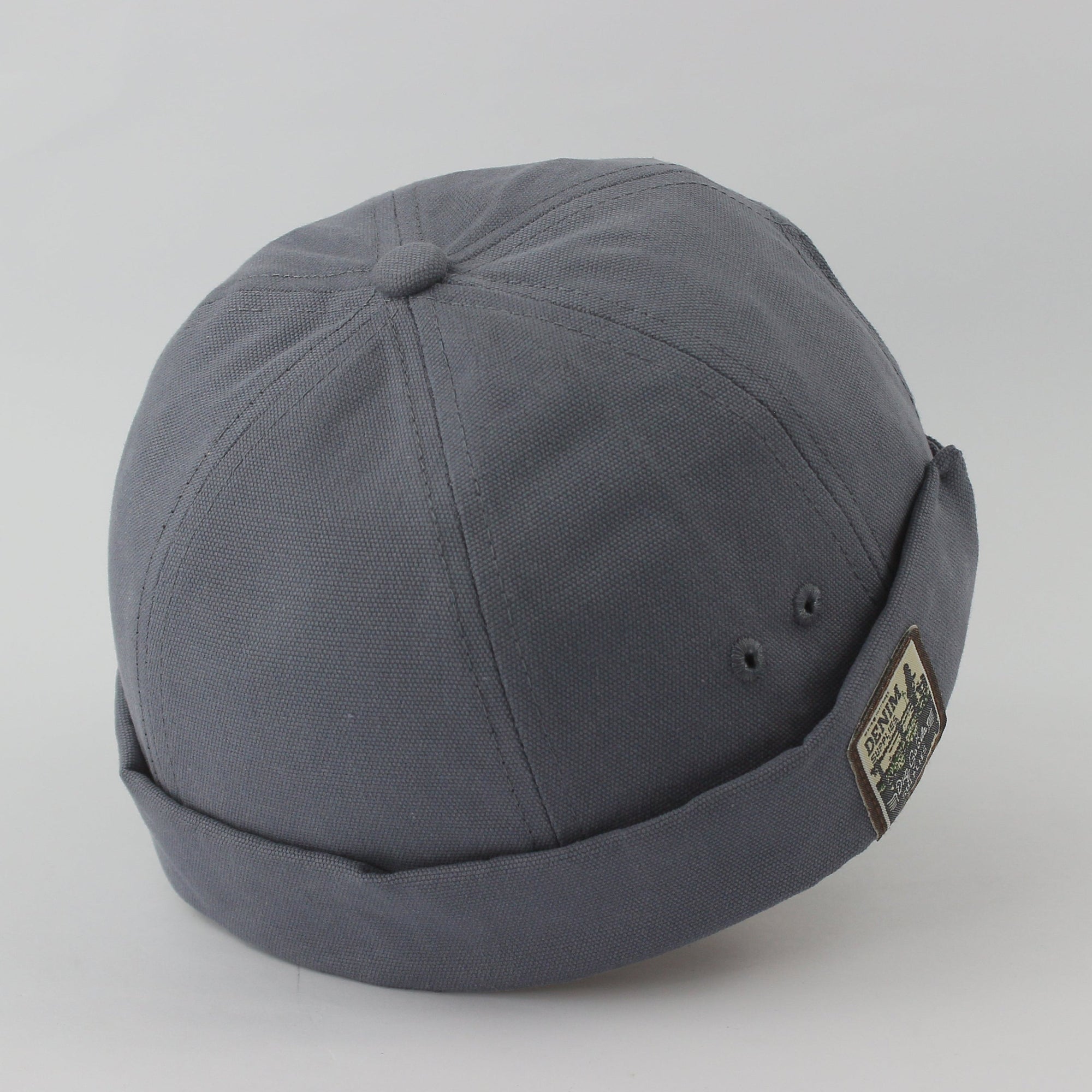 Gray cap with a patch on a light gray background