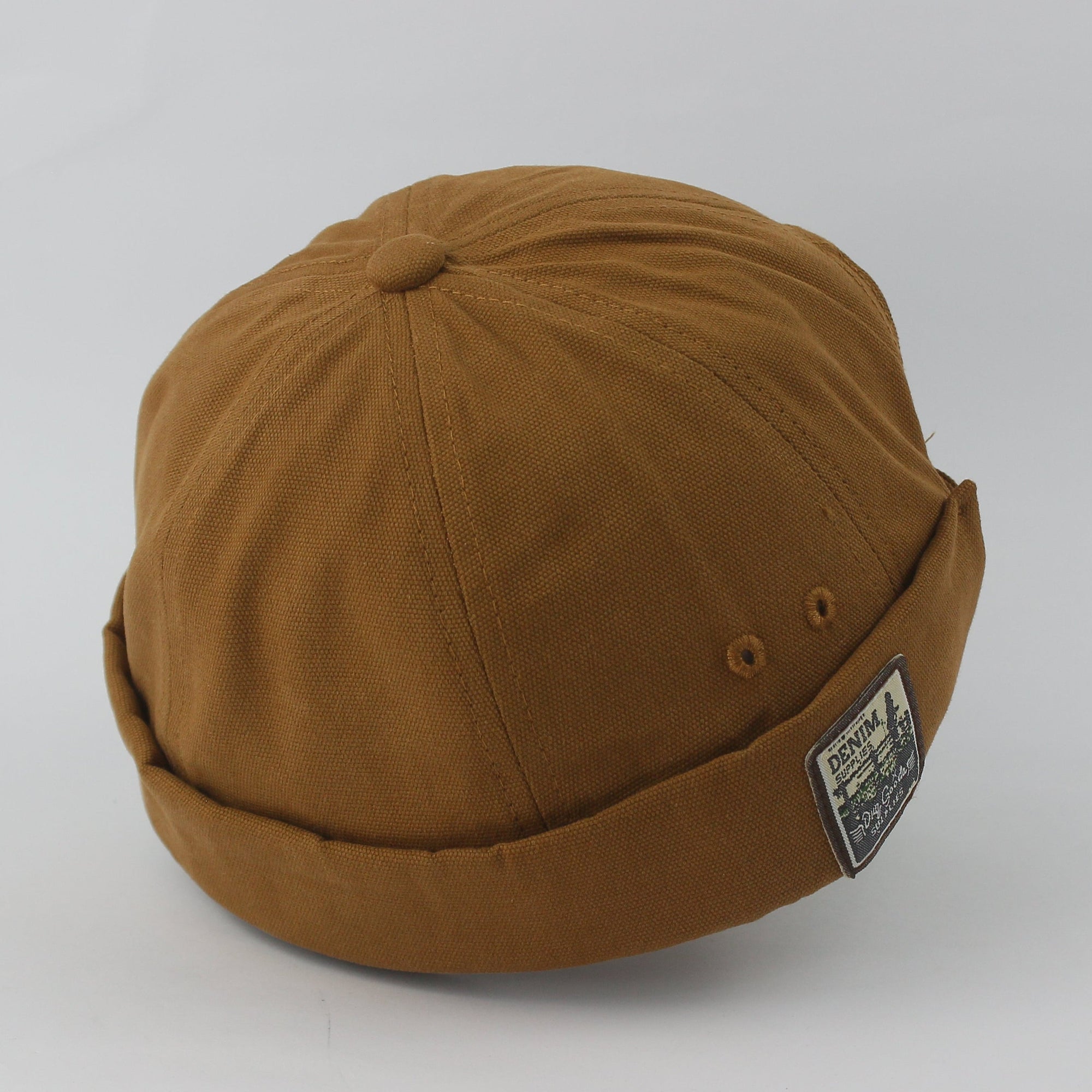 Brown cap with a patch on a light gray background
