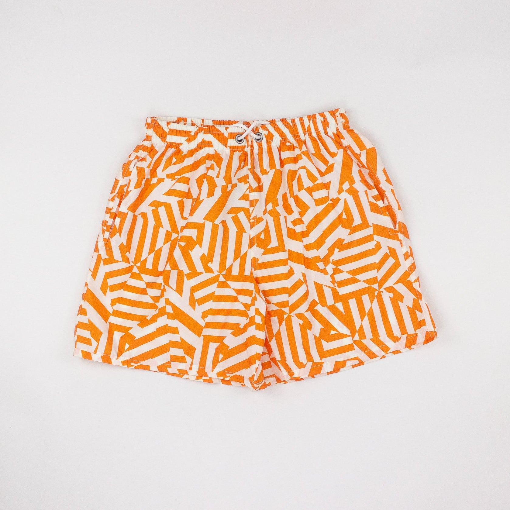 Orange and white patterned shorts on a light gray background